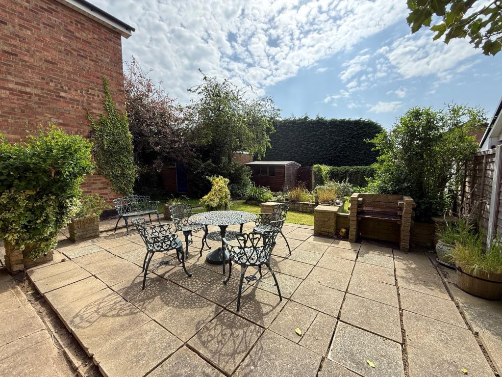 Lot: 100 - DETACHED HOUSE FOR IMPROVEMENT - Patio area with pathway leading to lawn, shed, garage and rear access gate